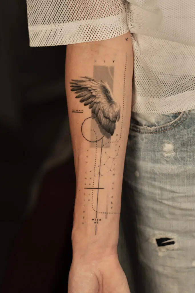 1 year 10 months healed tattoo - Wing and Typography Composition - Inner forearm - Vytautas Tattoo