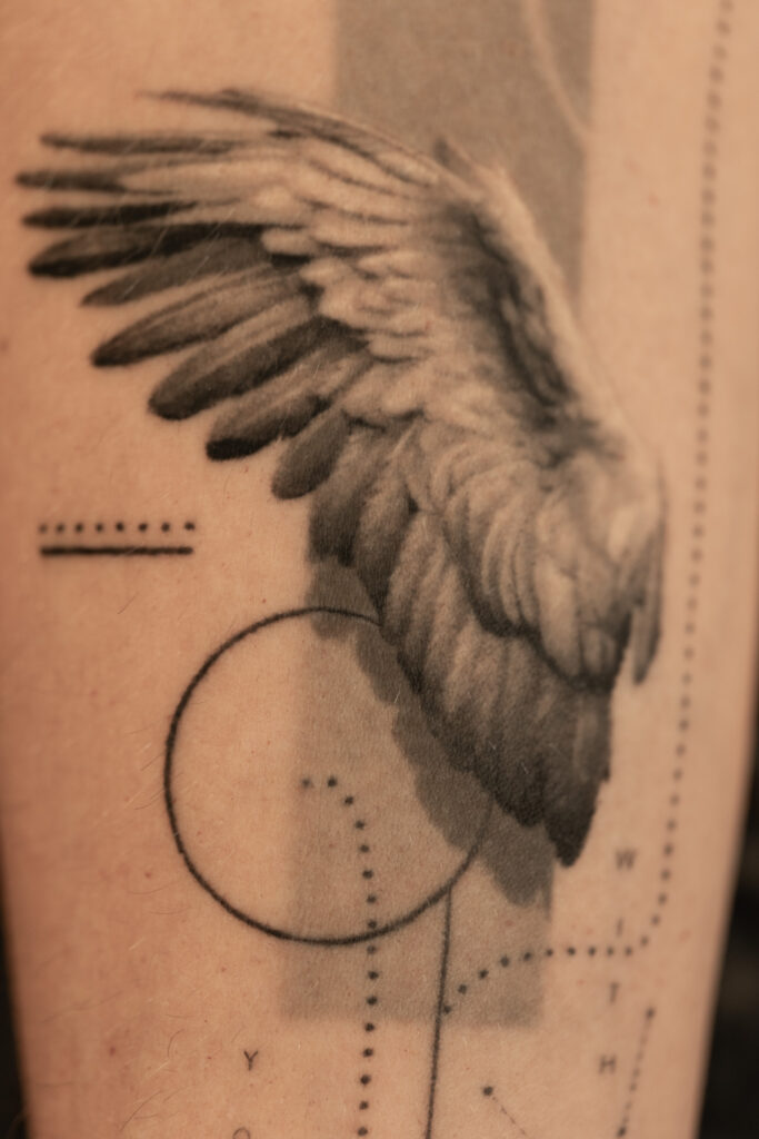 1 year 10 months healed tattoo - Wing and Typography Composition - Inner forearm - Vytautas Tattoo