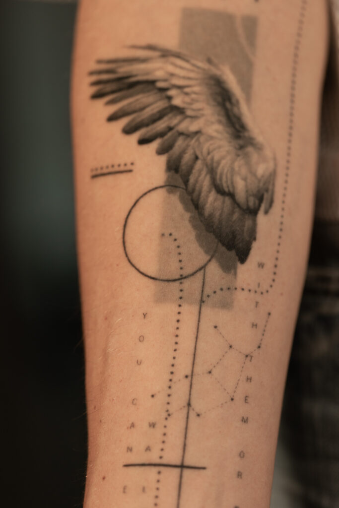 1 year 10 months healed tattoo - Wing and Typography Composition - Inner forearm - Vytautas Tattoo